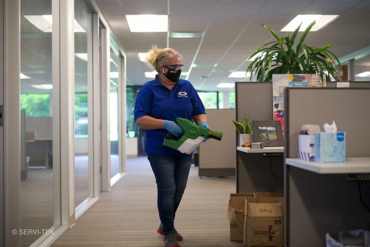 Janitors disinfecting cubicles