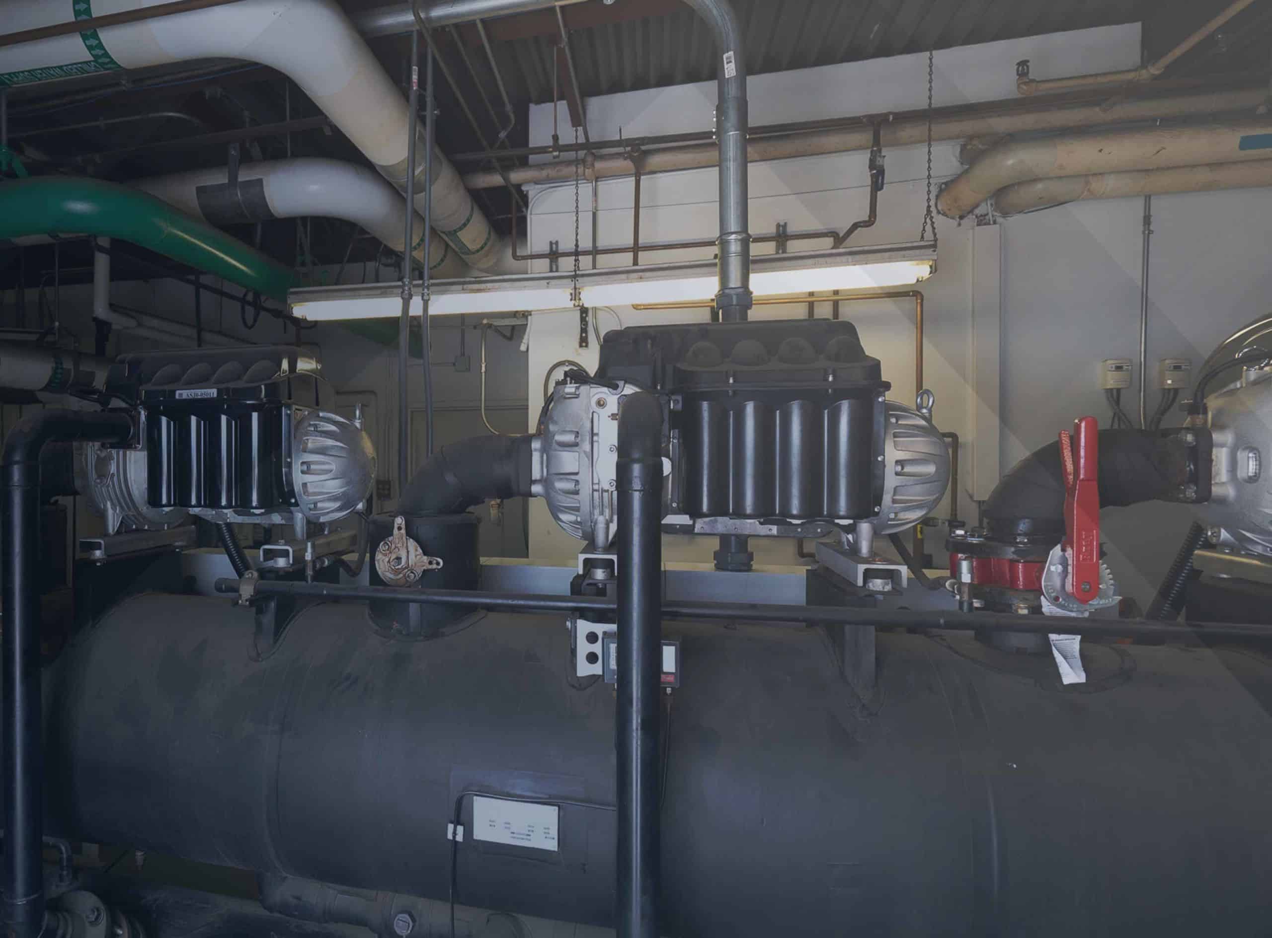 Servi-Tek technician inspecting a chiller control panel